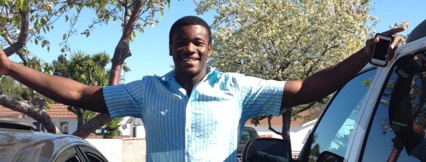 Young smiling male in blue shirt.