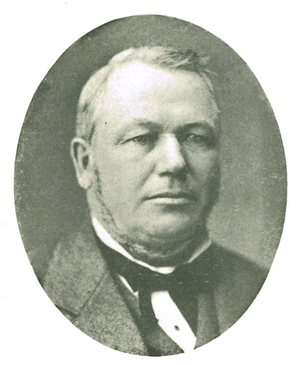 A black and white photo of a man in a tuxedo