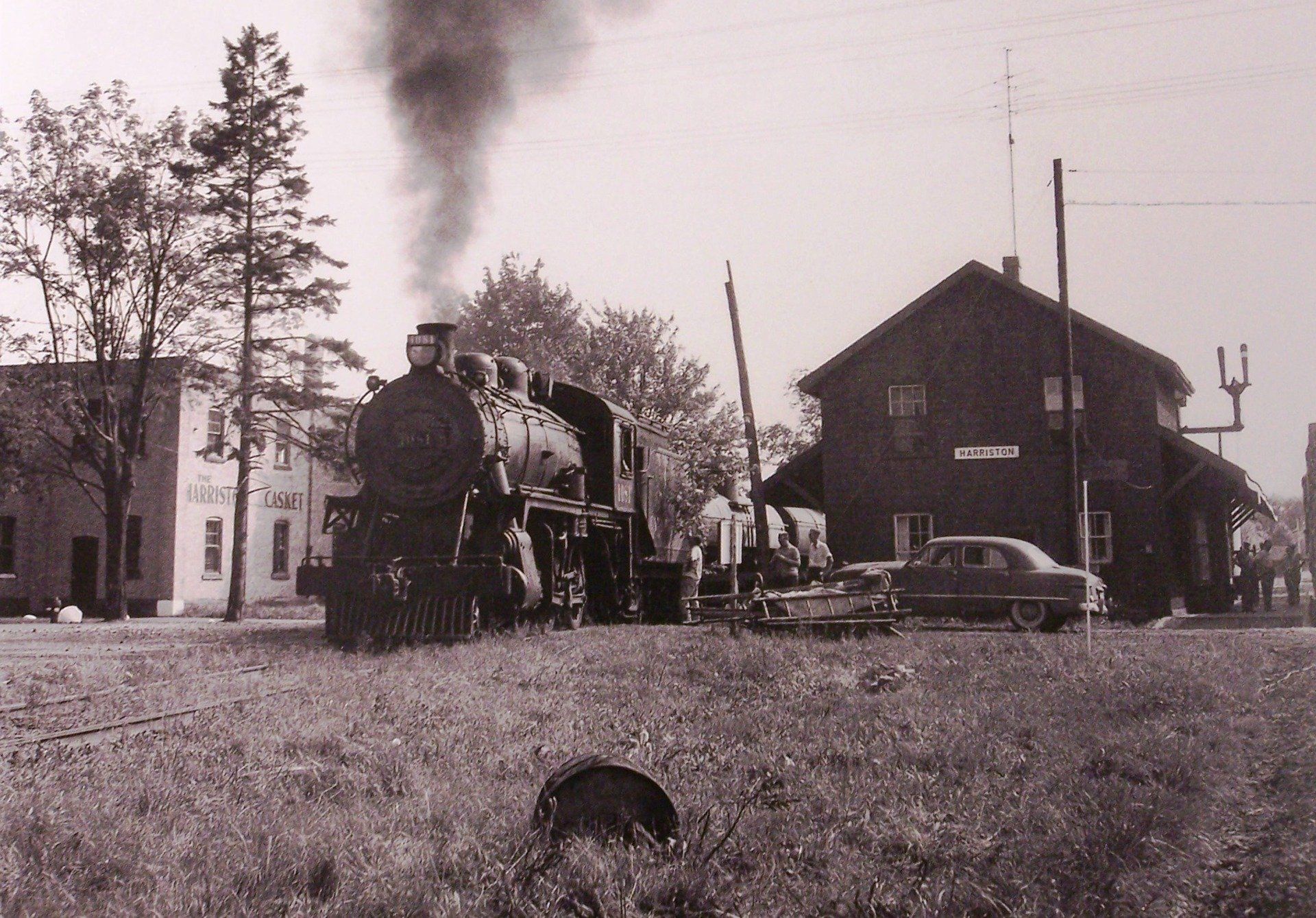 A black and white photo of a train station