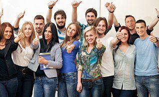 Coaching and Development image showing group of happy students celebrating  success