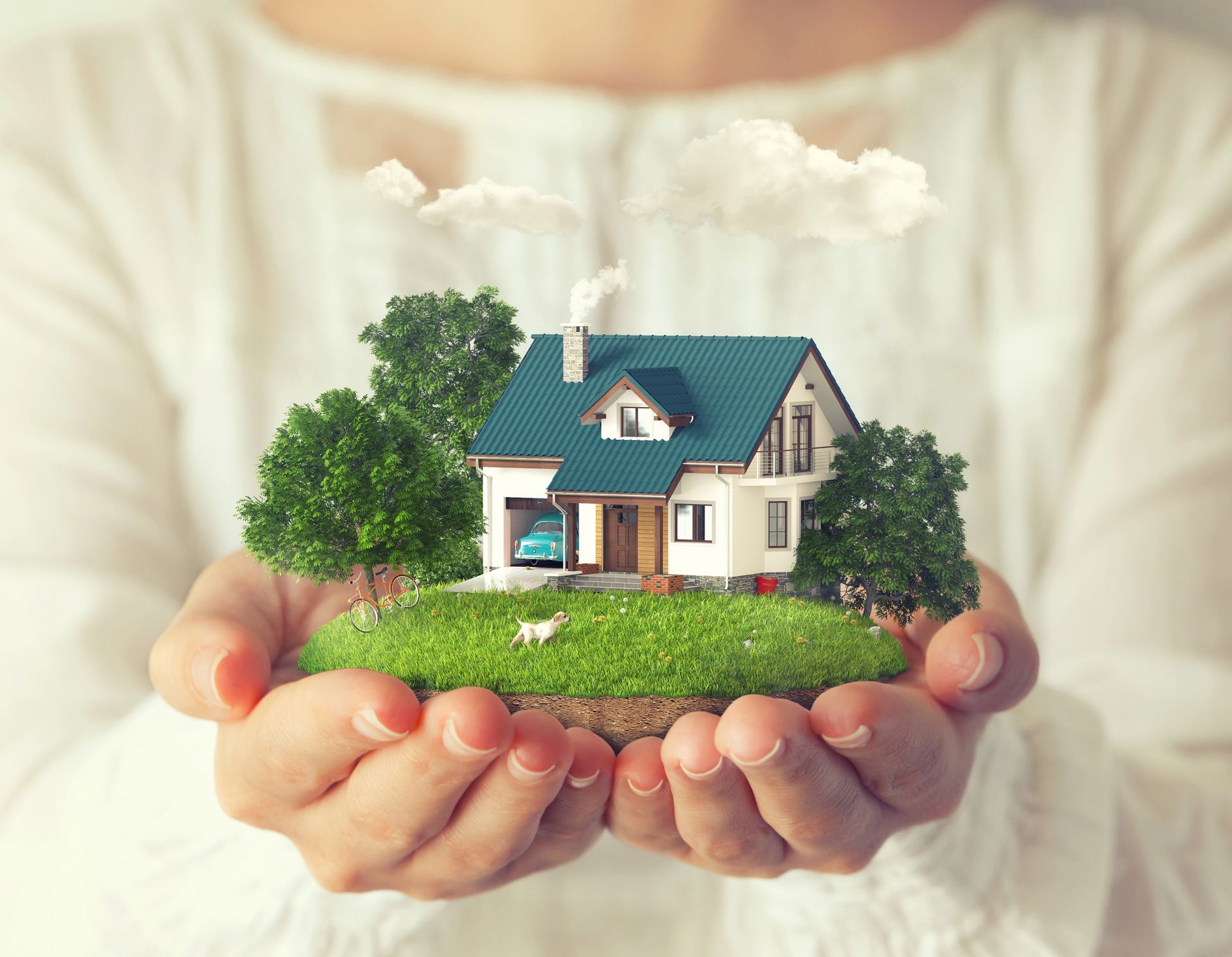 Die Hände sind zu Schalen geformt und halten ein Miniaturhaus, Gras, Bäume und Wolken.