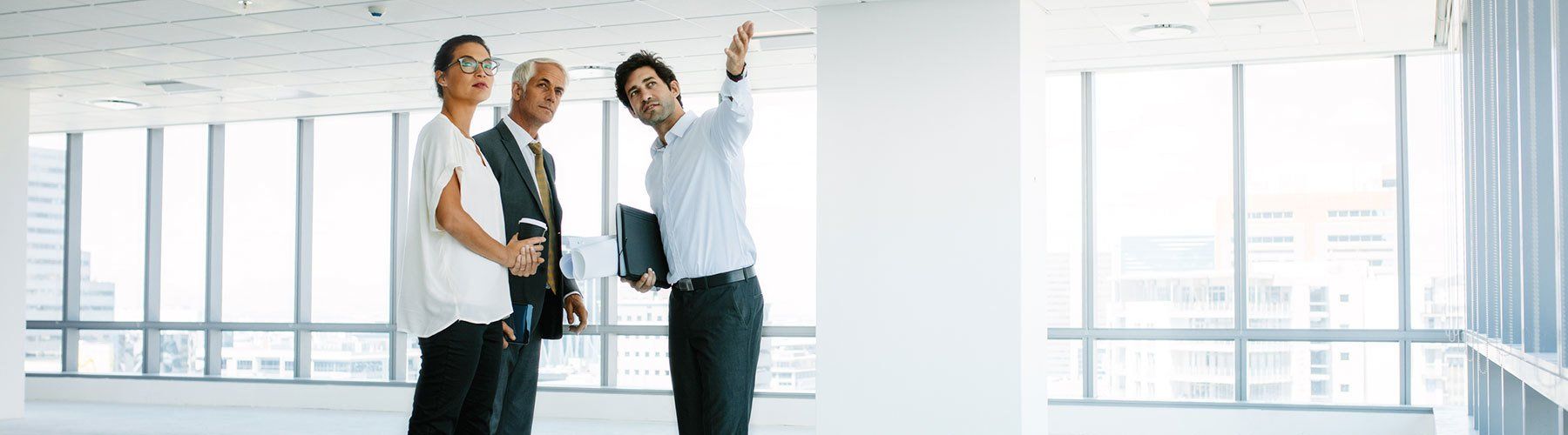 Real Estate Agent showing potential tenants new workspace.