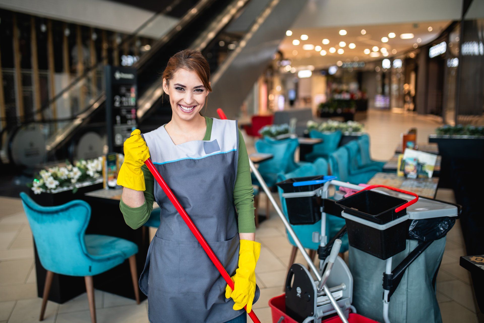 Beautiful young woman cleaning at shopping mall