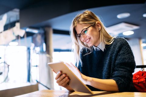 Hormone Imbalance — Smiling Woman Using Tablet in Goodyear, AZ Hormone Imbalance — Smiling Woman Using Tablet in Goodyear, AZ