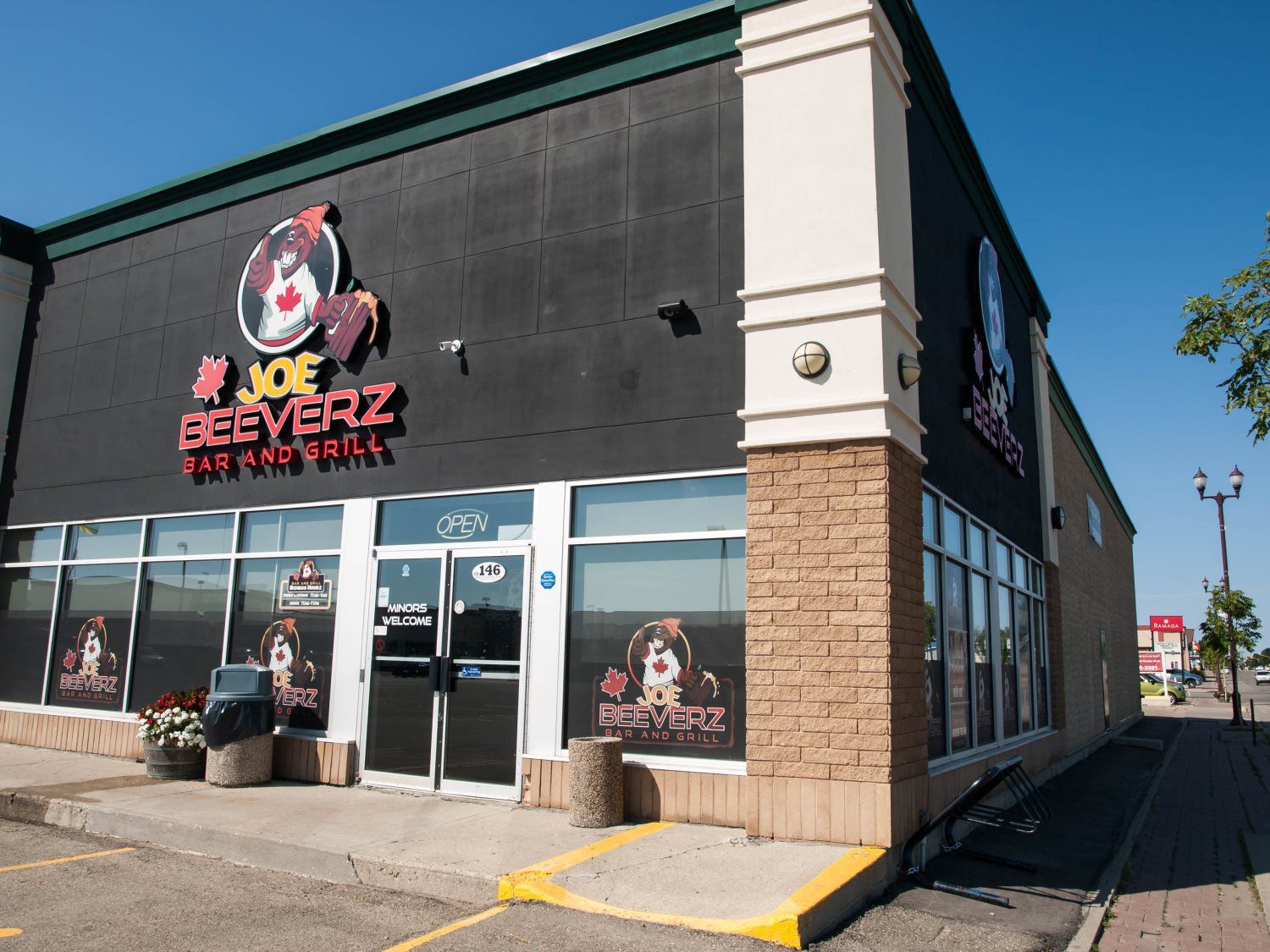 Joe Cecez restaurant exterior with black and white facade, glass storefront, and sidewalk parking lot