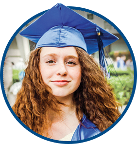 A young woman wearing a blue graduation cap and gown