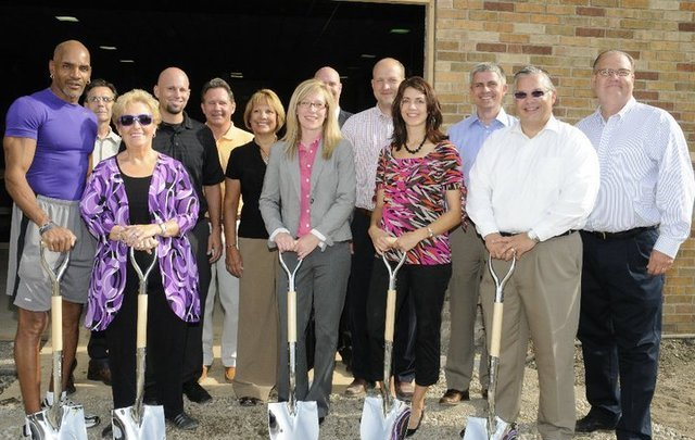 Boys & Girls Club of Lenawee Board of Directors standing next to each other holding shovels