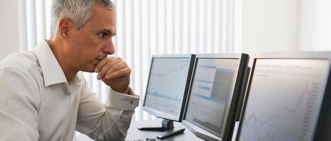 Data centre solutions brought to you by Marrick Commercial Interiors. Call 01483 306 500 Office worker looking at data on monitors