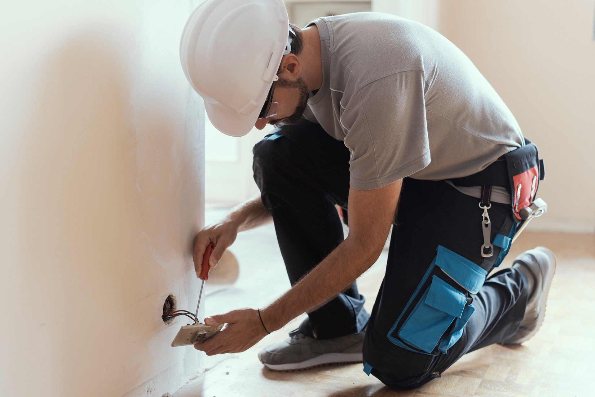 Professional electrician installing electrical socket — Belleville, IL — Jarvis Electric