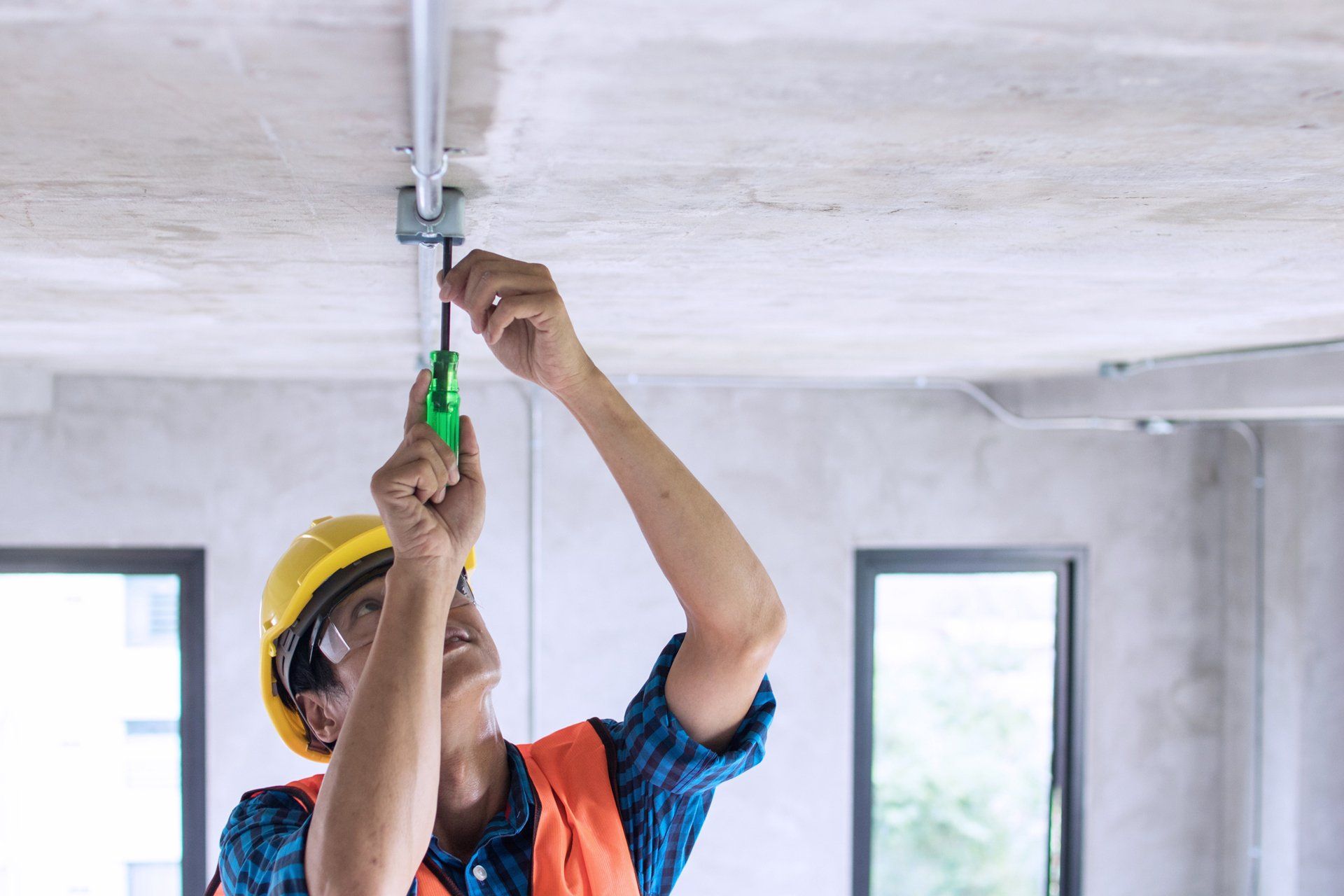 Professional electrician installing bulb electrical line — Belleville, IL — Jarvis Electric Professional electrician installing bulb electrical line — Belleville, IL — Jarvis Electric