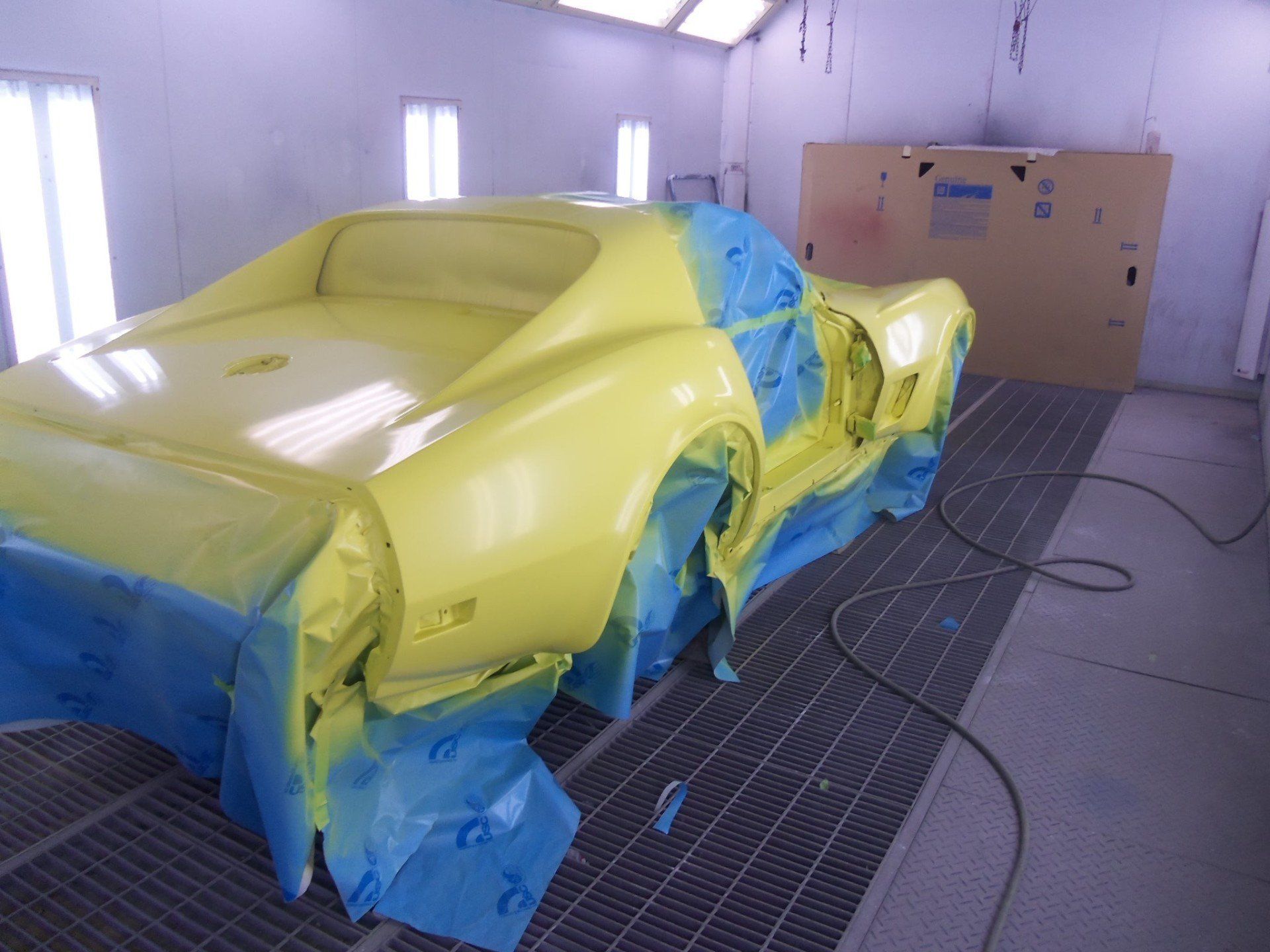 Yellow Vintage Car in Painting Booth — Villas, NJ — John's Auto Body