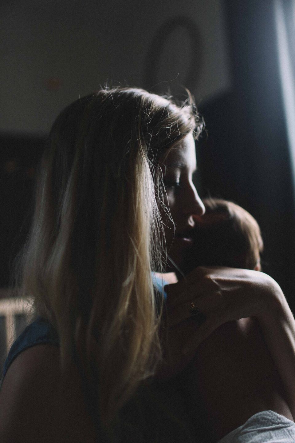 Mother holding her baby and looking worried