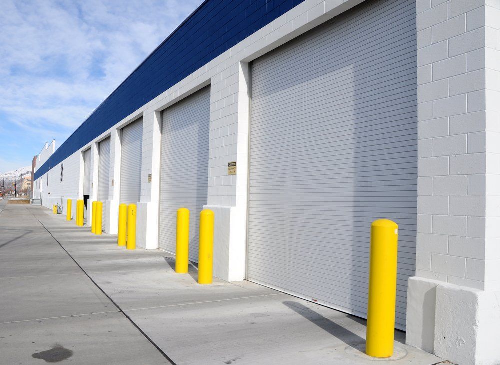 A number of industrial garage doors along a street