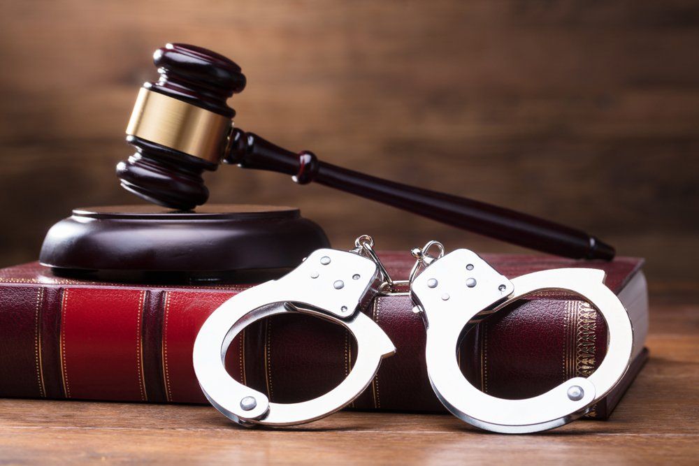 Gavel and Handcuffs on Law Book — Inverness, FL — Joseph Indelicato, P.A.