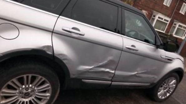 Silver range rover evoque damaged side panel