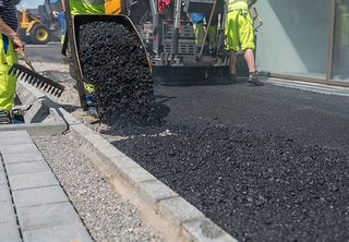 Asphalt Paving — Asphalt Unloaded From A Wheelbarrow In Gainesville, TX Asphalt Paving — Asphalt Unloaded From A Wheelbarrow In Gainesville, TX