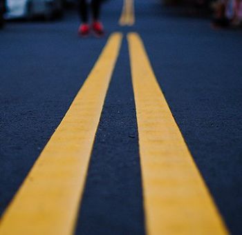Seal Coating — New Asphalt Road With Yellow Lane In Gainesville, TX Seal Coating — New Asphalt Road With Yellow Lane In Gainesville, TX