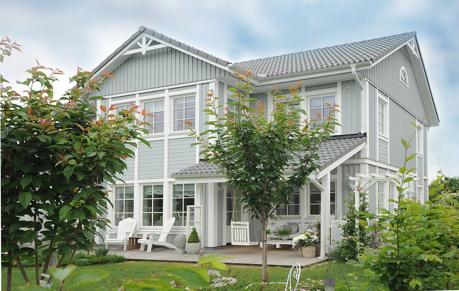 A large white house with a lot of windows and a porch