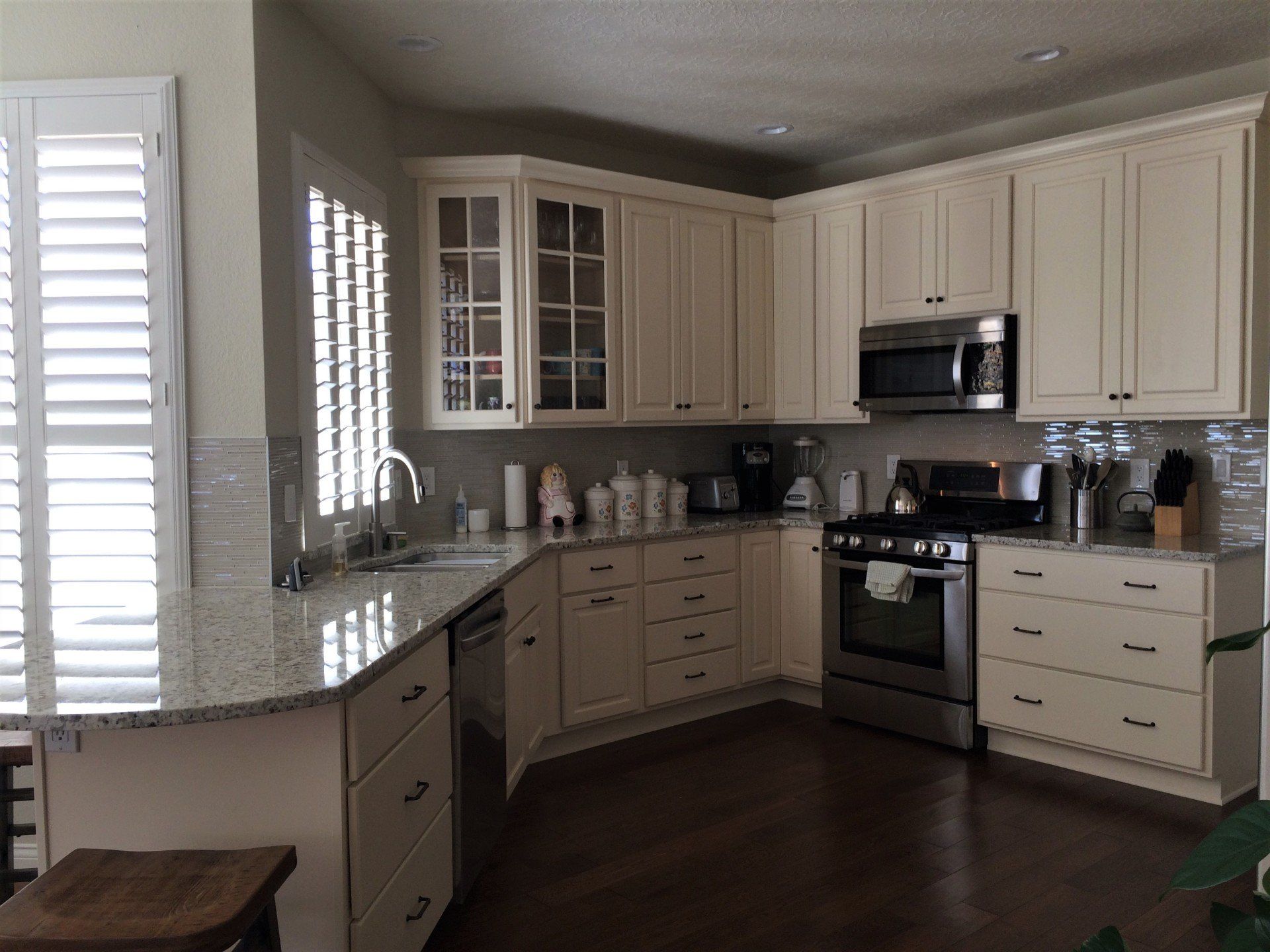 A kitchen with white cabinets and stainless steel appliances