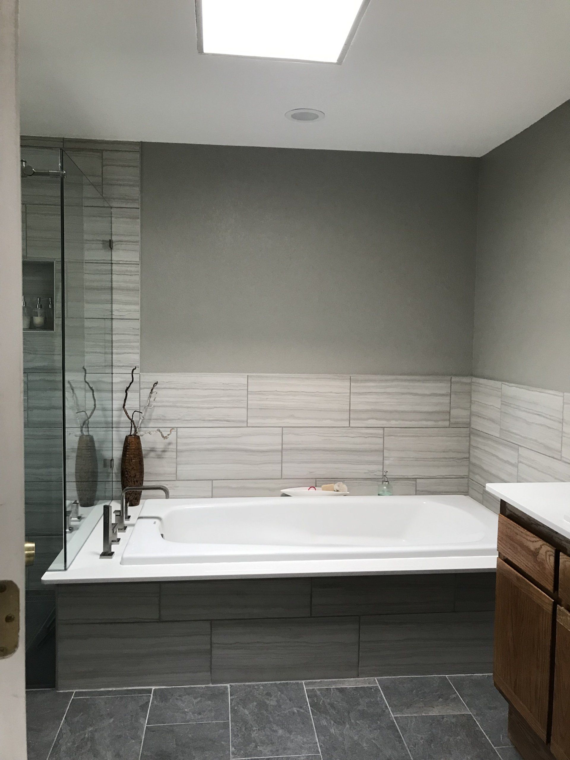 A bathroom with a large tub and a sink.