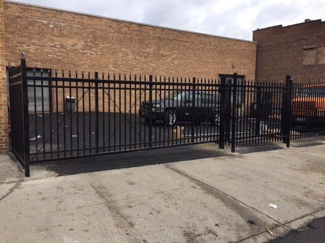 Cars inside a black fence—Security Fence in Bronx, NY