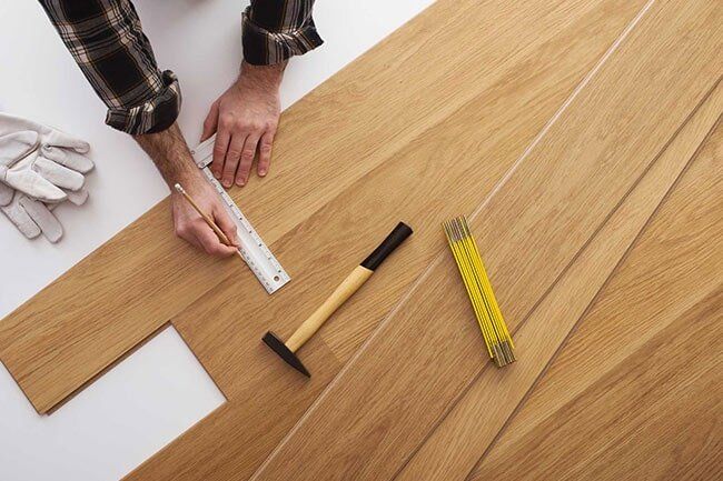 Floor Mechanic Installing A Wooden Flooring — Floor Repair in Gales Ferry, CT