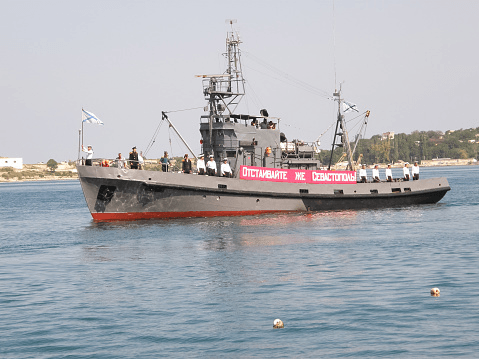 A large ship is floating on top of a body of water.