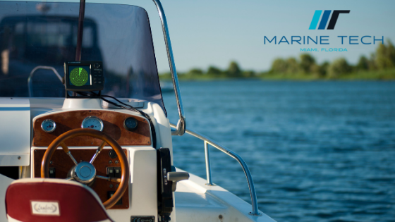 A boat with a steering wheel and a marine tech logo in the background