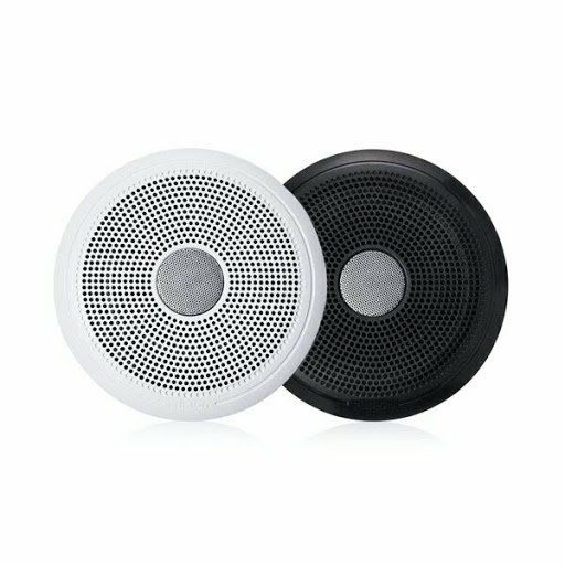 A pair of speakers , one white and one black , are sitting next to each other on a white surface.