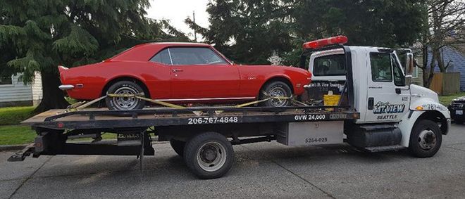 Towing — Red Car on Tow Truck in Seattle, WA Towing — Red Car on Tow Truck in Seattle, WA