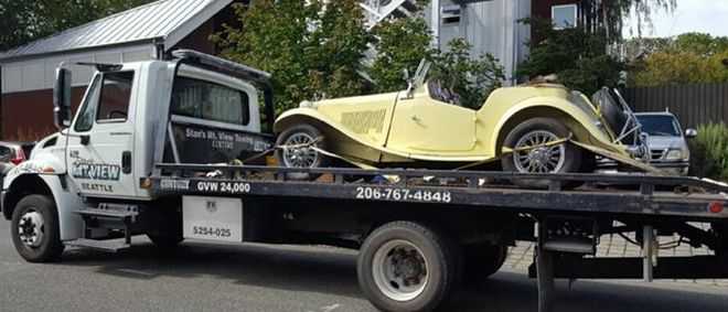 Heavy Duty Towing — Yellow Car on Tow Truck in Seattle, WA Heavy Duty Towing — Yellow Car on Tow Truck in Seattle, WA
