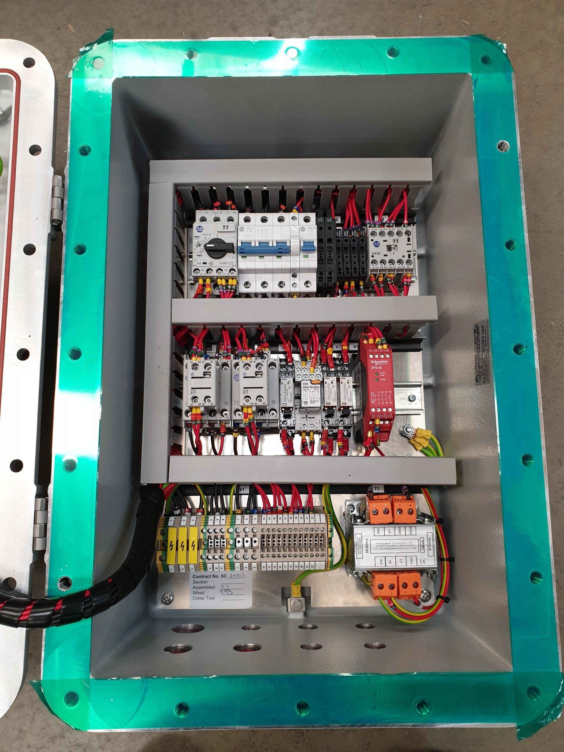 Top view of a control panel without the door and exposing all the wiring and relays