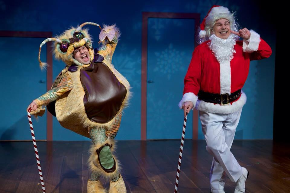 2 actors wearing colorful costumes and holding striped canes