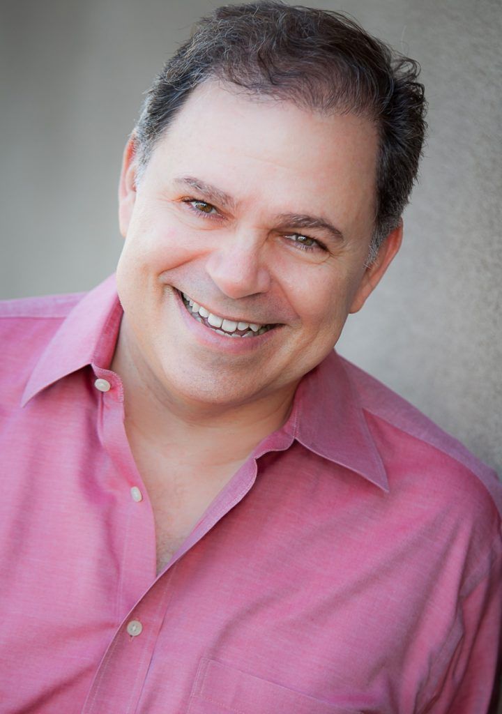 Phil, laughing, in light pink dress shirt
