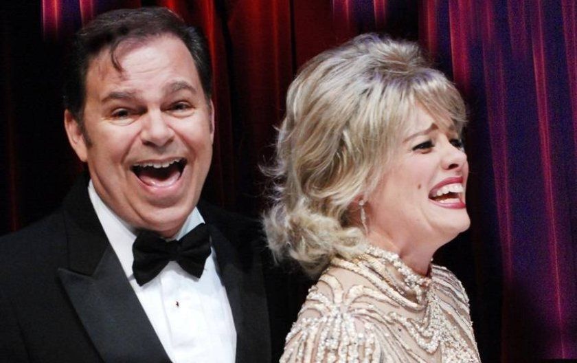 2 actors onstage laughing and singing