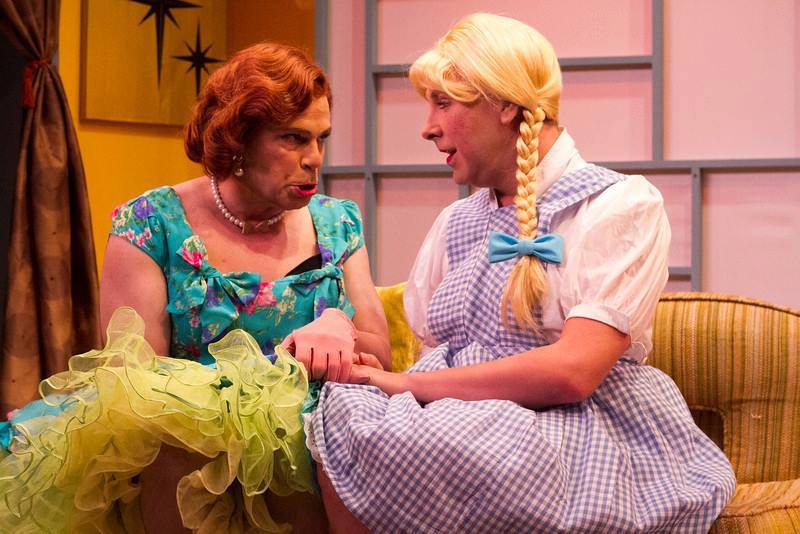 2 actors onstage dressed women during scene from the play