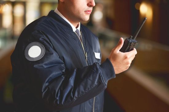 custodian with walkie-talkie