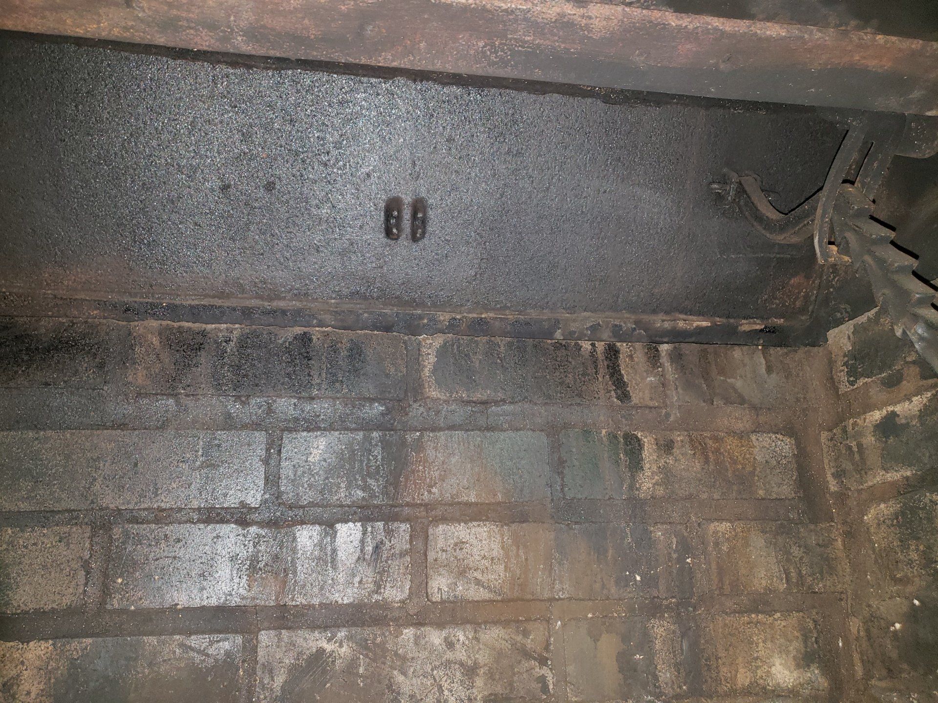 A close up of a brick wall with a few holes in it.