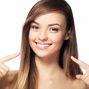 Pointing to teeth - Cleanings in Durant, OK Pointing to teeth - Cleanings in Durant, OK