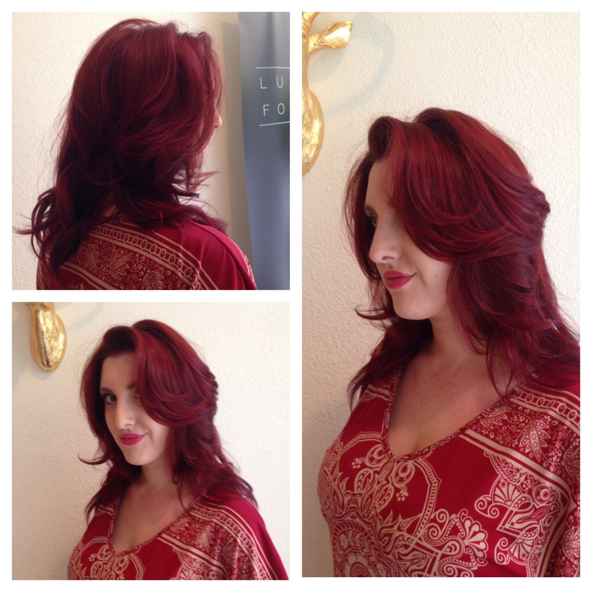 Woman with layered, auburn hair, wearing a red top, posing for photos.