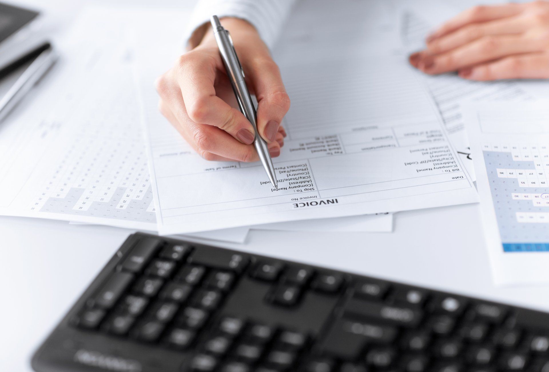 A person checking over an invoice
