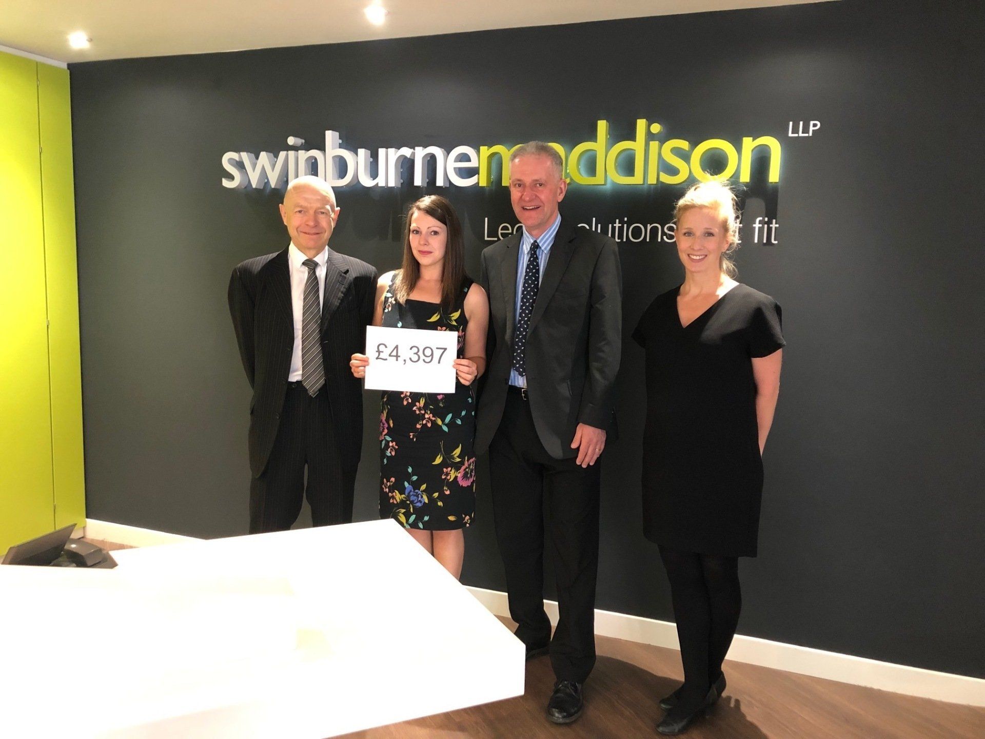 A group of people standing in front of a sign that says swinburne addison
