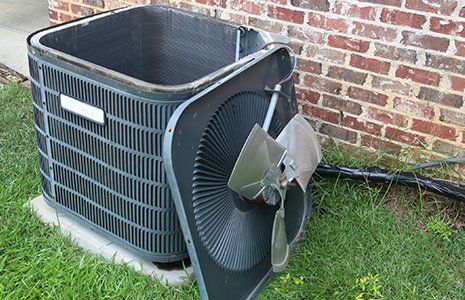 AC Repair — Fan Off Top of AC Condenser During Maintenance in Concord, NC AC Repair — Fan Off Top of AC Condenser During Maintenance in Concord, NC