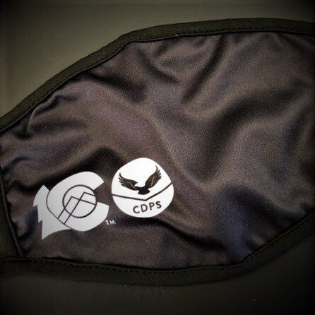 A black face mask with a cdps logo on it