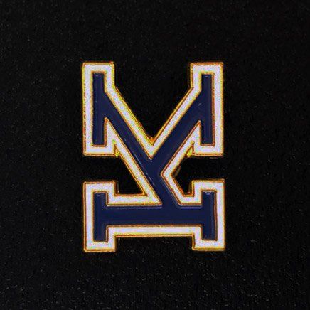 A blue and white pin with the letter m on it