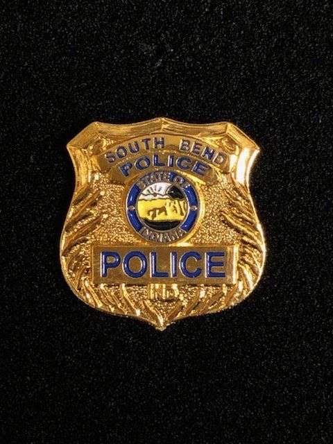 A south bend police badge on a black background