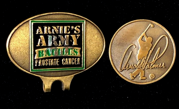 A golf ball marker that says arnie 's army battles prostate cancer
