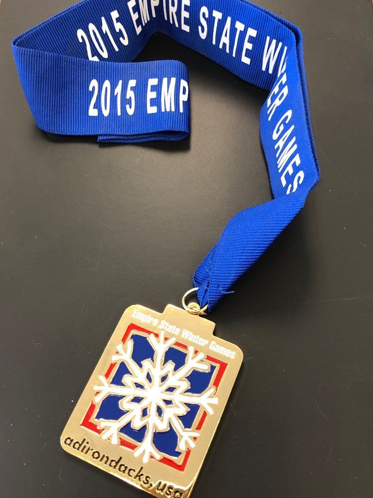 A medal that says 2015 emp on it
