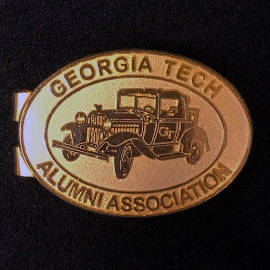 A georgia tech alumni association belt buckle with an old car on it