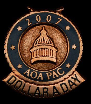A coin that says 2007 aoa pac dollar a day